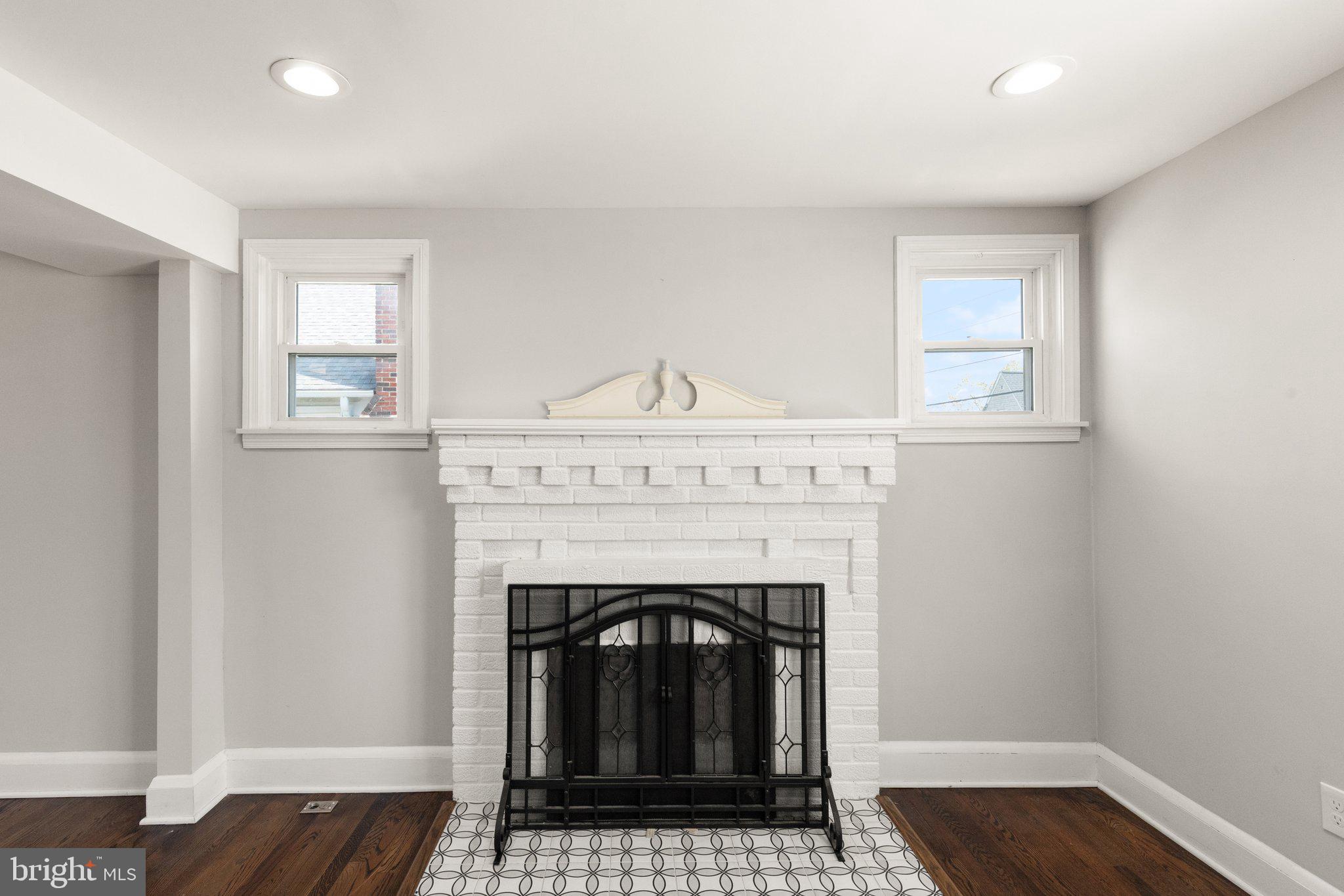 7512 Brightside Avenue Baltimore, MD 21237 - Photo 5 of 32 a living room with a fireplace and wooden floor
