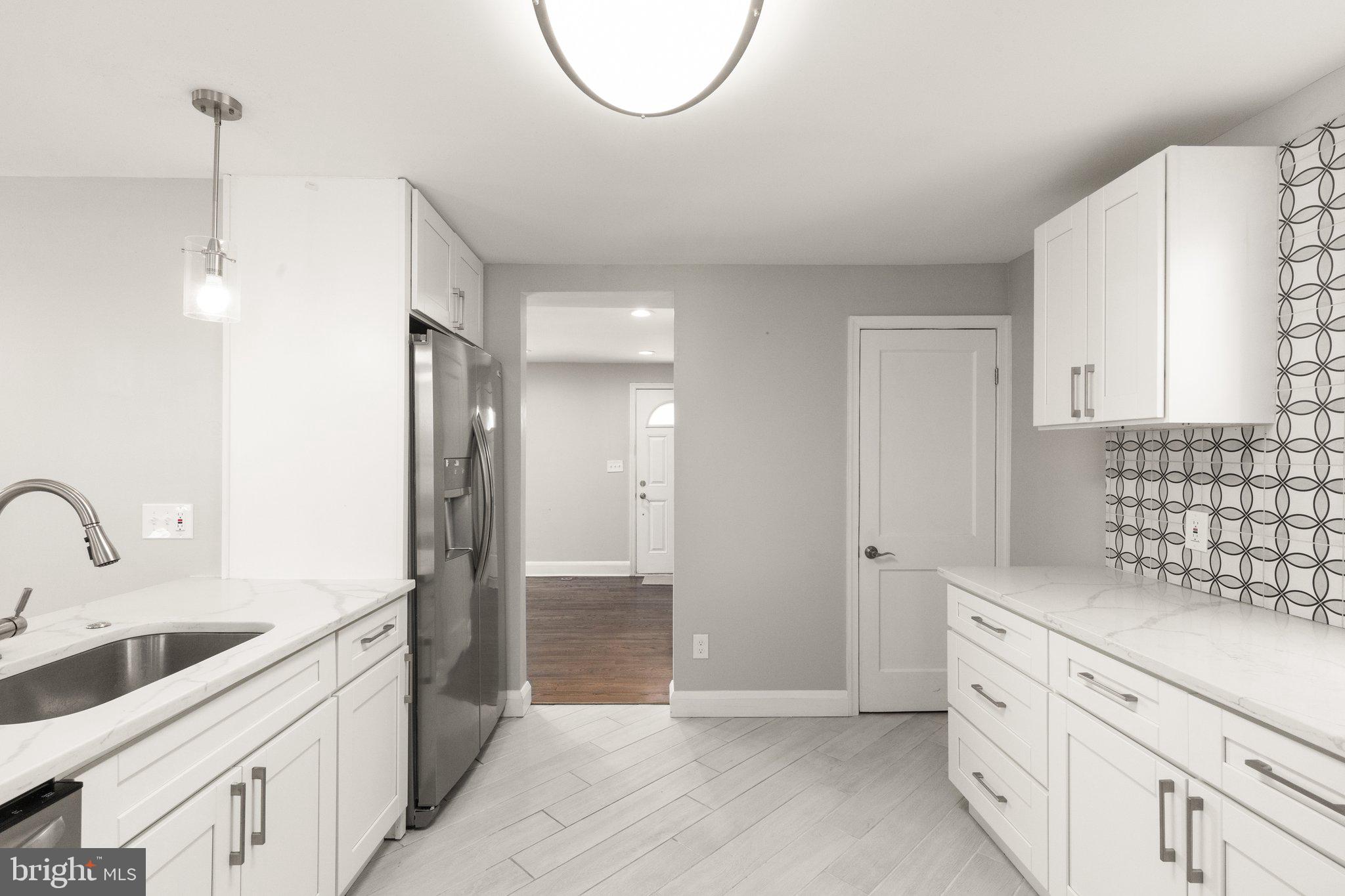 7512 Brightside Avenue Baltimore, MD 21237 - Photo 9 of 32 a spacious bathroom with double vanity sink and a mirror