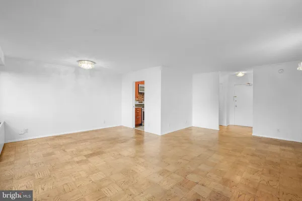 a view of an empty room and closet area