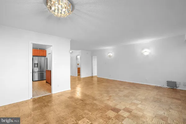 a kitchen with stainless steel appliances granite countertop a refrigerator a stove and a wooden cabinets