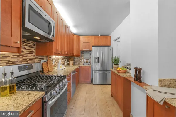 a kitchen with a stove and a refrigerator