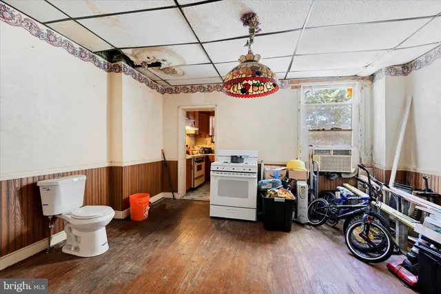 a view of a room with furniture gym equipment and wooden floor