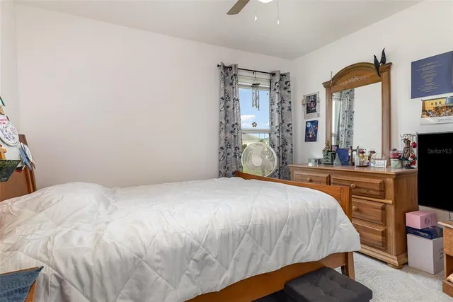 a bathroom with a granite countertop toilet a sink and a mirror