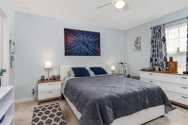 a bedroom with a bed and a lamp