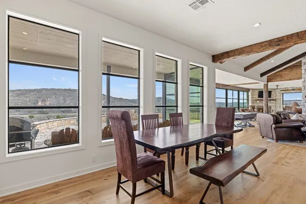 a large white kitchen with a large window
