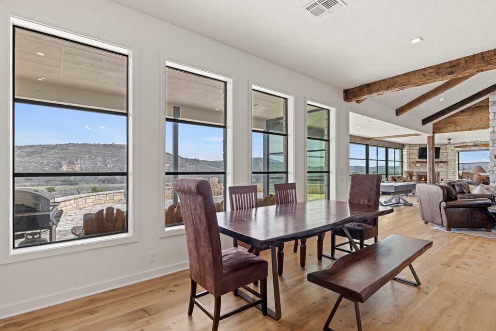 256 Persimmon Point Mason, TX 76856 - Photo 16 of 60 a dining room with furniture large windows and wooden floor