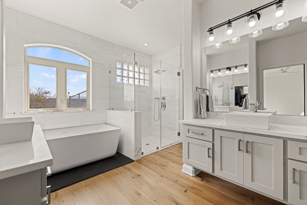 256 Persimmon Point Mason, TX 76856 - Photo 21 of 60 a spacious bathroom with a double vanity sink a mirror and a bathtub