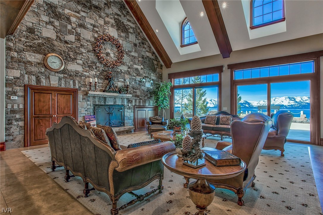 550 Sierra Sunset Lane Zephyr Cove, NV 89448 - Photo 11 of 35 a living room with furniture a fireplace and a large window