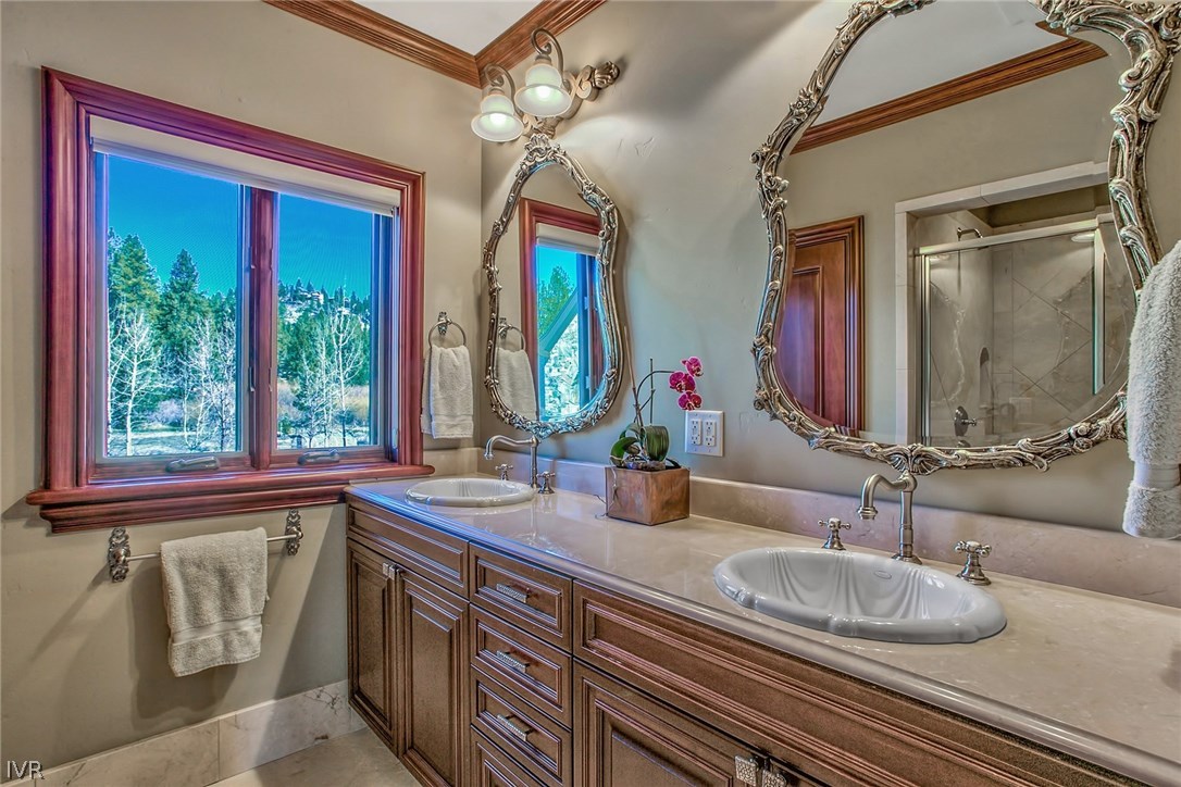 550 Sierra Sunset Lane Zephyr Cove, NV 89448 - Photo 29 of 35 a bathroom with a granite countertop sink and a mirror