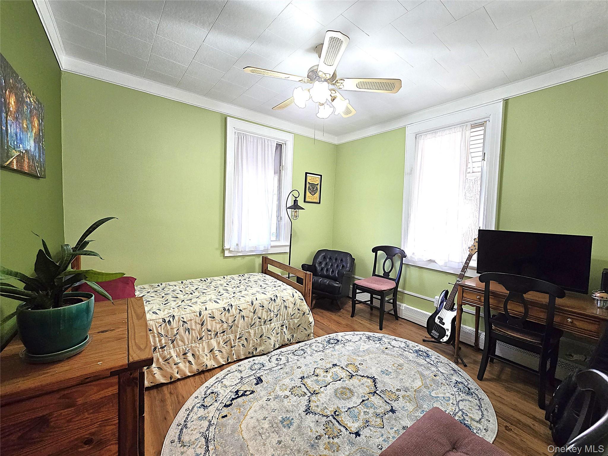 16 Daisy Place Selden, NY 11784 - Photo 12 of 19 a bedroom with a bed and a potted plant