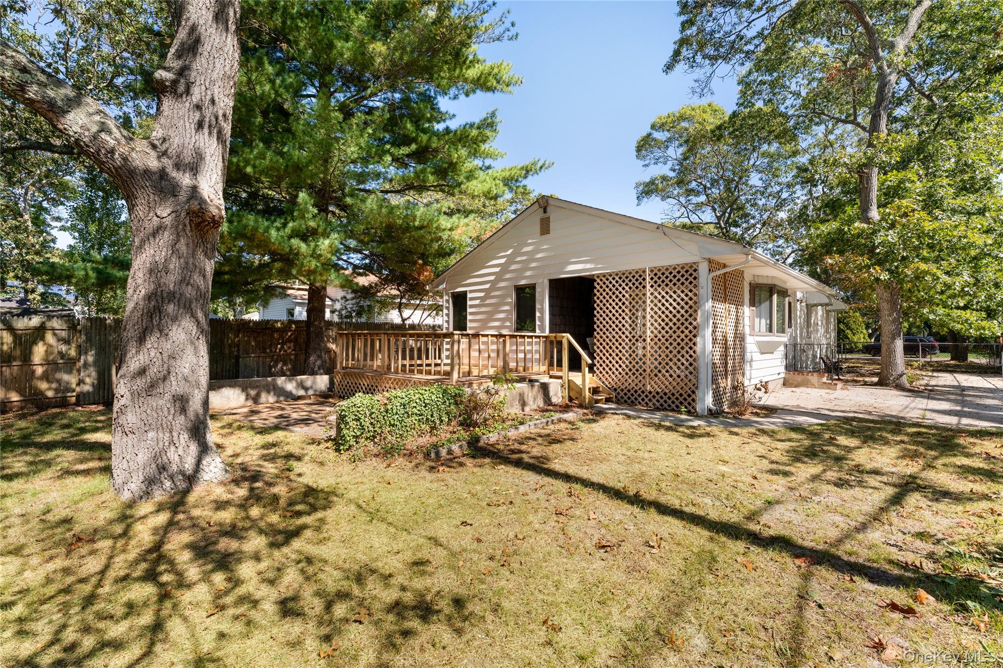 16 Daisy Place Selden, NY 11784 - Photo 16 of 19 a view of a yard with a tree in the house