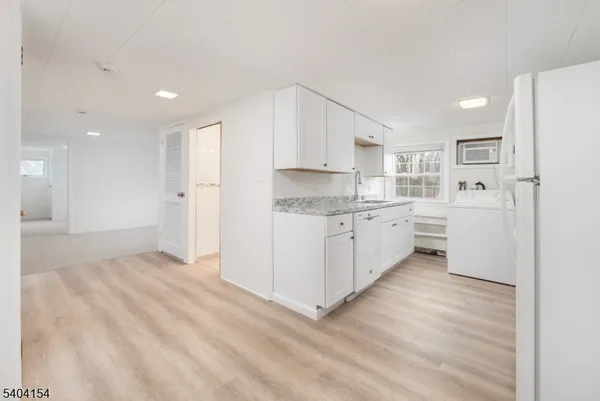 a view of a kitchen with a sink and cabinets