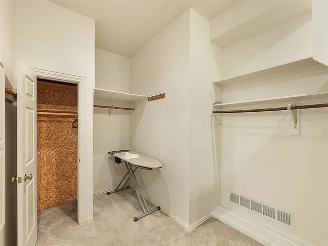 a bathroom with a shower and a chair