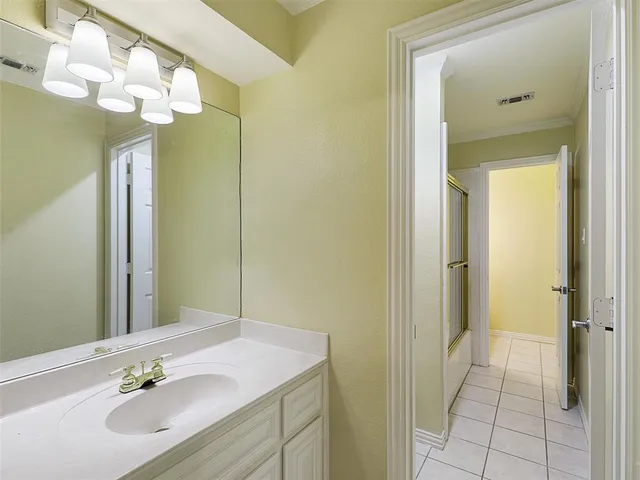 a bathroom with a sink a mirror and a shower