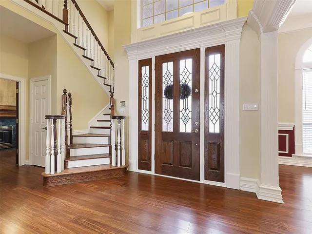 a view of an entryway with wooden floor and door