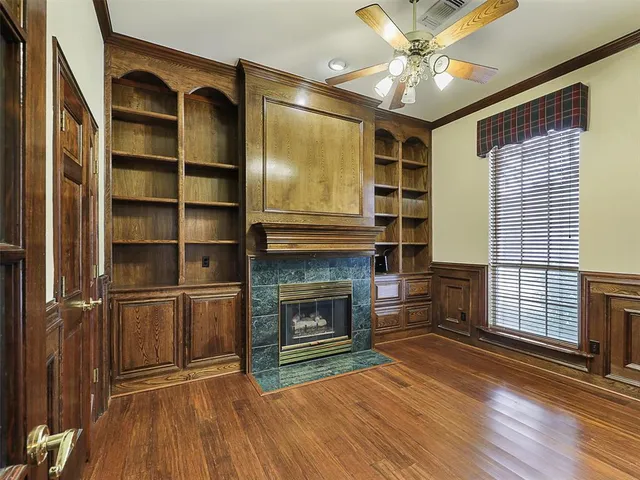 a view of an empty room with a fireplace and a window