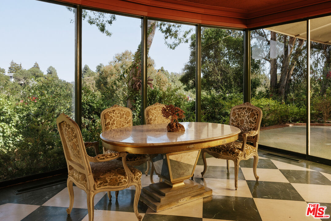 10934 Bellagio Road Los Angeles, CA 90077 - Photo 16 of 47 a view of a patio with a table chairs and a table