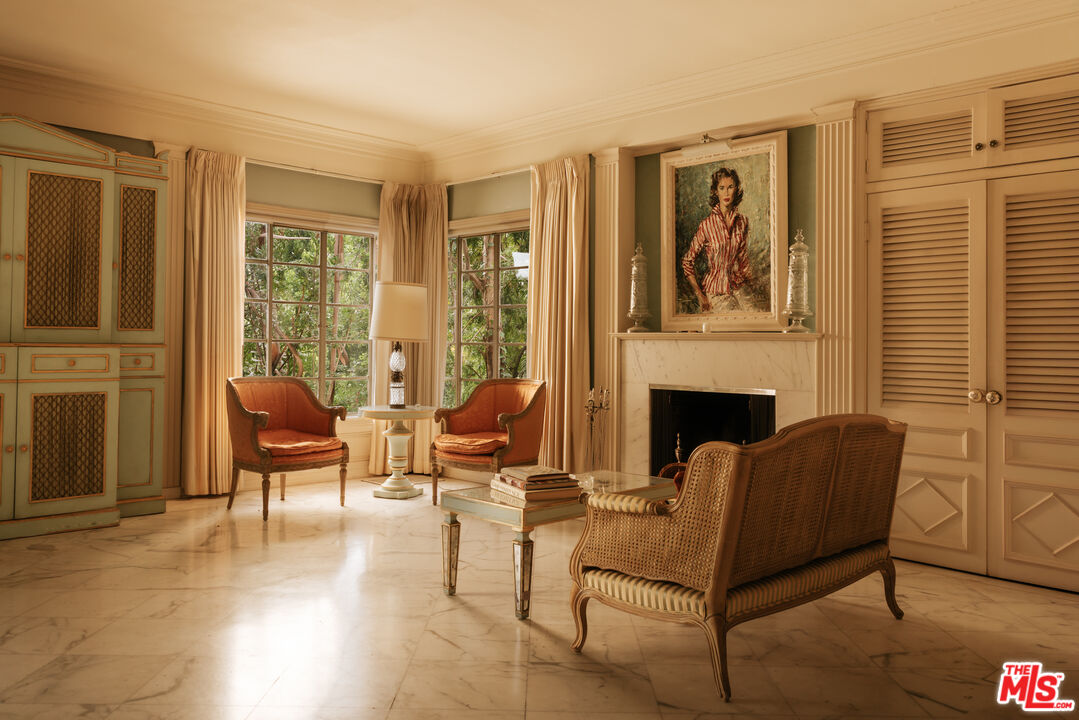 10934 Bellagio Road Los Angeles, CA 90077 - Photo 17 of 47 a living room with furniture a fireplace and a large window