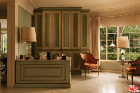 a work room with furniture and large windows