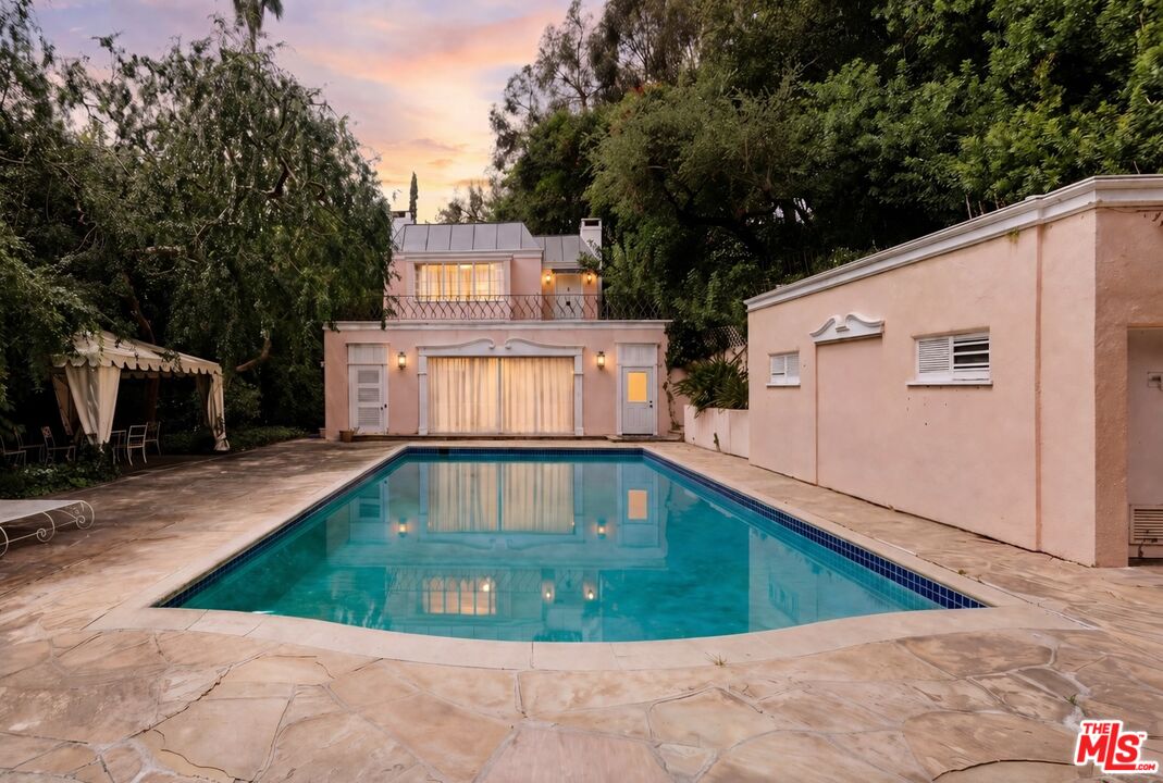 10934 Bellagio Road Los Angeles, CA 90077 - Photo 3 of 47 a view of a swimming pool with a yard