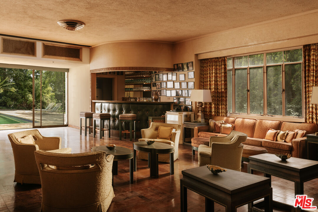 10934 Bellagio Road Los Angeles, CA 90077 - Photo 4 of 47 a living room with fireplace furniture and a large window