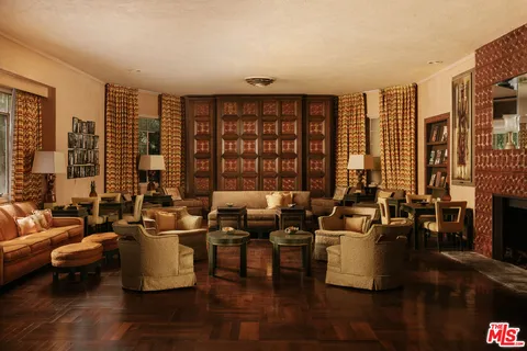 a living room with furniture and large windows
