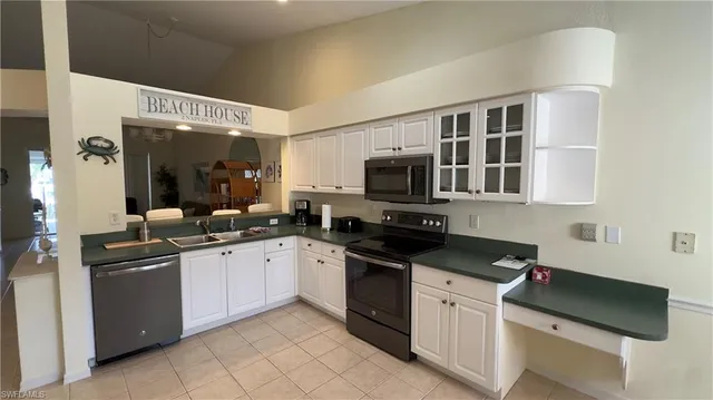 a kitchen with stainless steel appliances granite countertop a sink and dishwasher a stove top oven with wooden floor