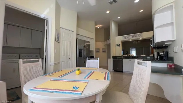 a kitchen with stainless steel appliances kitchen island granite countertop a sink refrigerator and cabinets