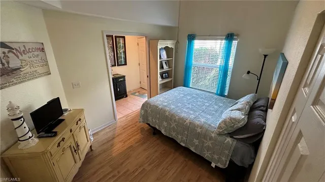 a bedroom with a bed and wooden floor