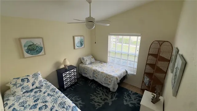 a bedroom with a bed and a mirror on dresser