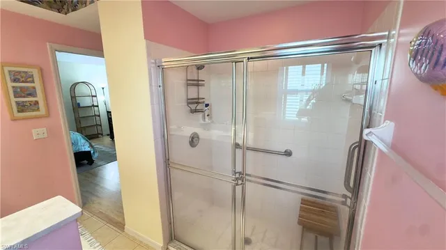 a bathroom with a glass shower door and a sink