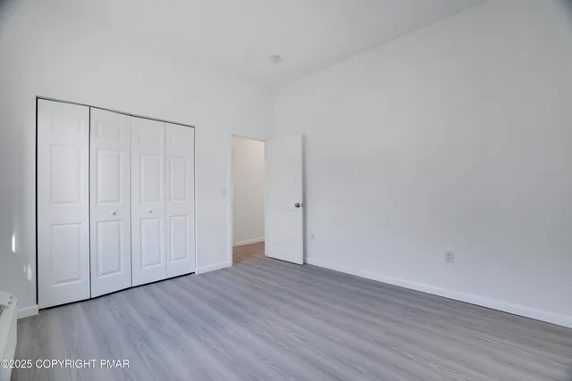 a view of an empty room and wooden floor