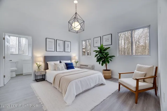 a bedroom with a bed and a potted plant