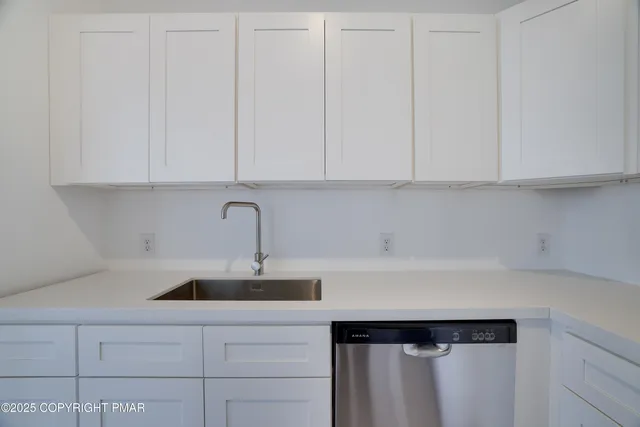a kitchen with a sink and cabinets