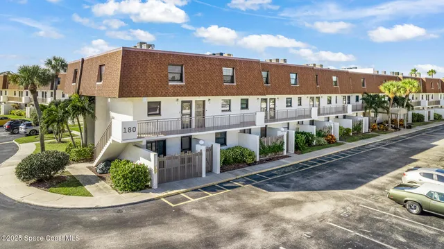 a view of a large building with a yard
