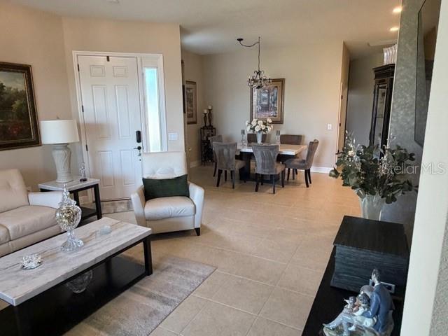 1759 Nottingham Trail Punta Gorda, FL 33980 - Photo 5 of 27 a living room with furniture and a chandelier