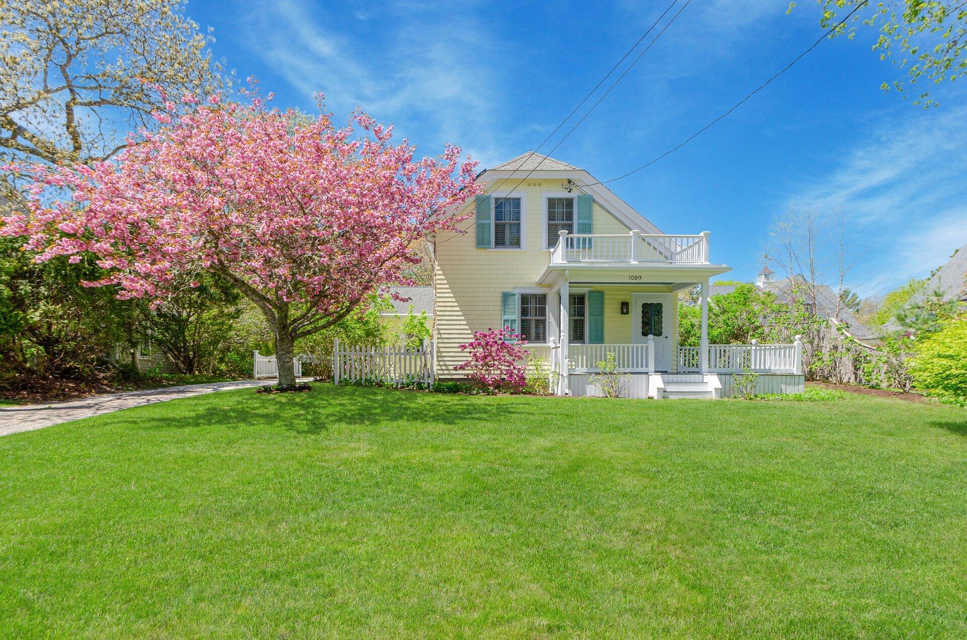 1089 Main Street Cotuit, MA 02635 - Photo 37 of 41 a front view of a house with a garden