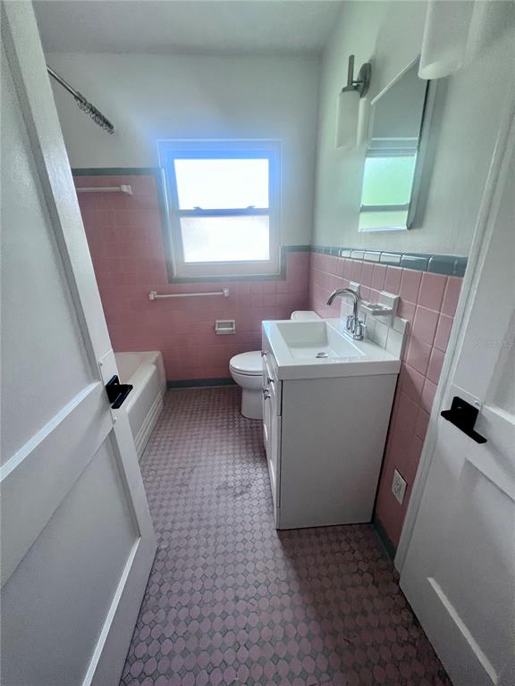 2707 Northwest 4th Avenue Gainesville, FL 32607 - Photo 12 of 31 a bathroom with a sink a toilet and mirror