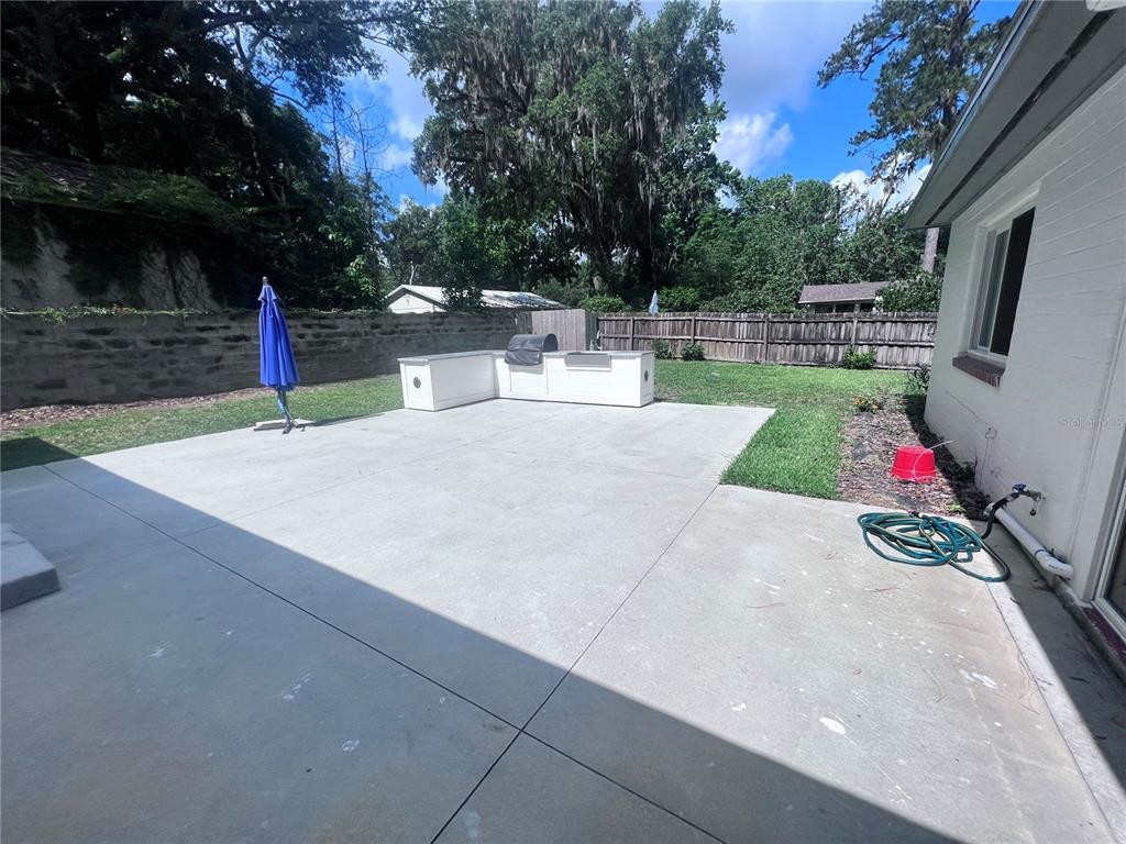 2707 Northwest 4th Avenue Gainesville, FL 32607 - Photo 15 of 31 a backyard of a house with table and chairs