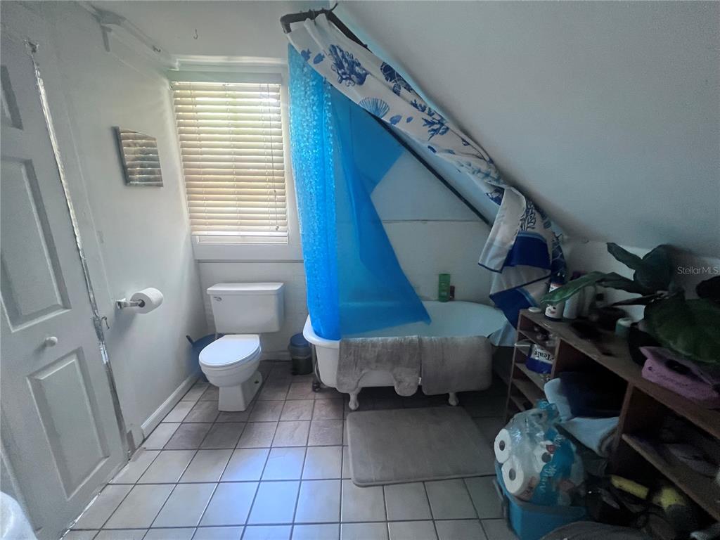 2707 Northwest 4th Avenue Gainesville, FL 32607 - Photo 20 of 31 a living room with furniture and a toilet