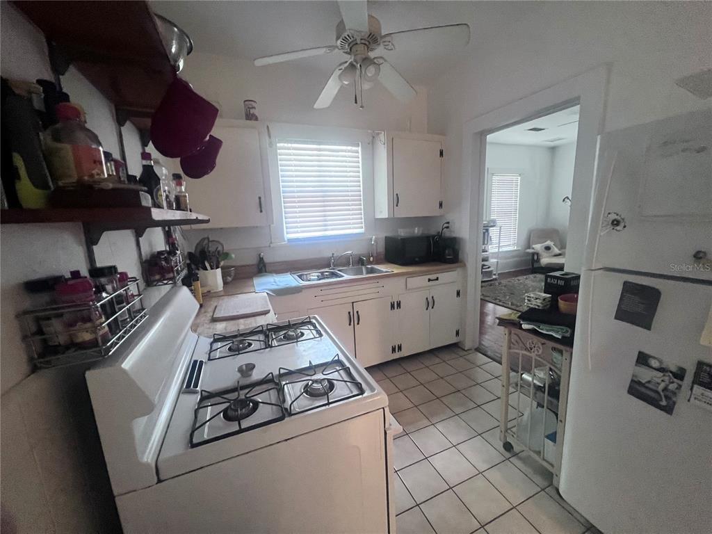 2707 Northwest 4th Avenue Gainesville, FL 32607 - Photo 21 of 31 a kitchen with a sink appliances and cabinets