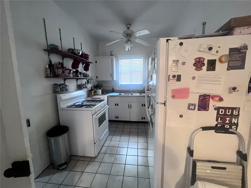 2707 Northwest 4th Avenue Gainesville, FL 32607 - Photo 22 of 31 a kitchen with a refrigerator a sink and wooden floor