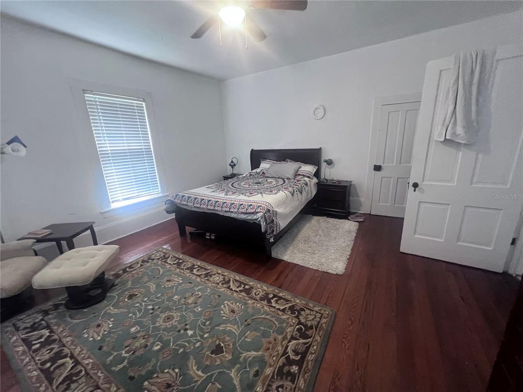 2707 Northwest 4th Avenue Gainesville, FL 32607 - Photo 23 of 31 a bedroom with a bed and wooden floor