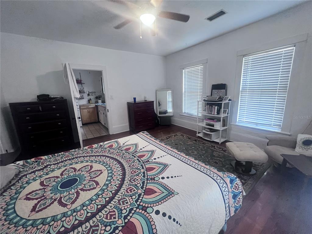 2707 Northwest 4th Avenue Gainesville, FL 32607 - Photo 24 of 31 a bedroom with a bed and wooden floor