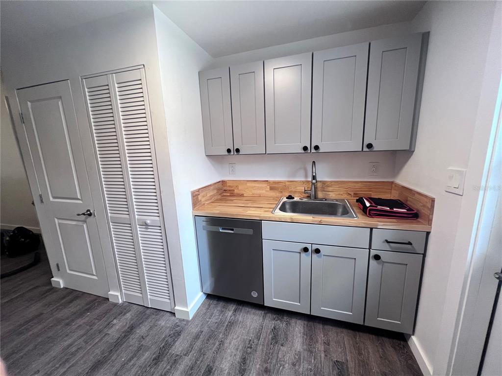 2707 Northwest 4th Avenue Gainesville, FL 32607 - Photo 30 of 31 a kitchen with a sink cabinets and wooden floor