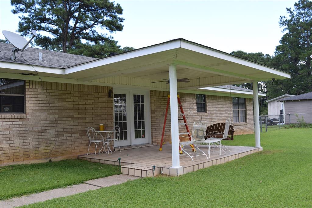 Covered patio featuring a tiled surface and white support columns