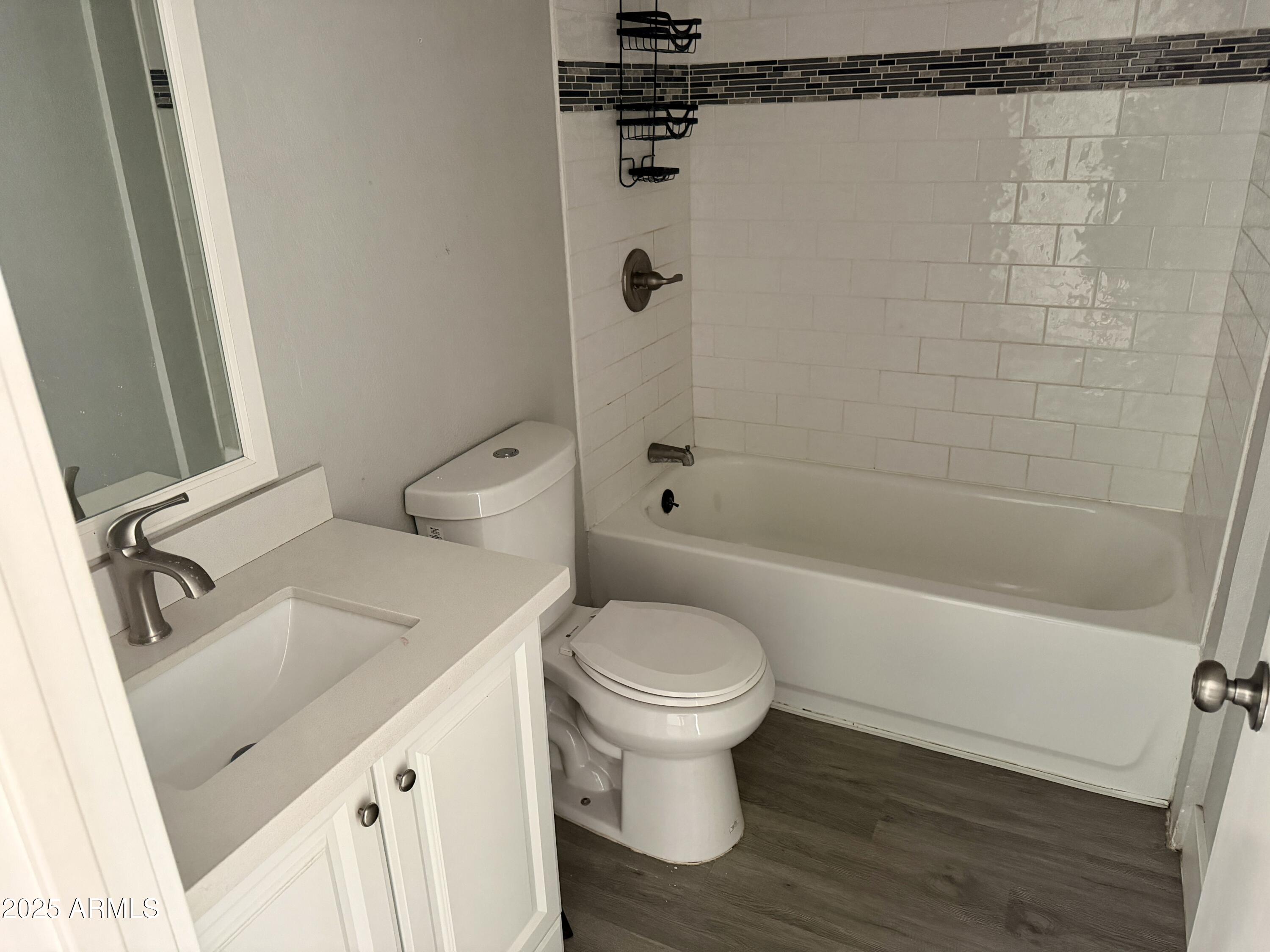 5027 North 16th Avenue, Unit 1 Phoenix, AZ 85015 - Photo 6 of 9 a bathroom with a sink a toilet and shower