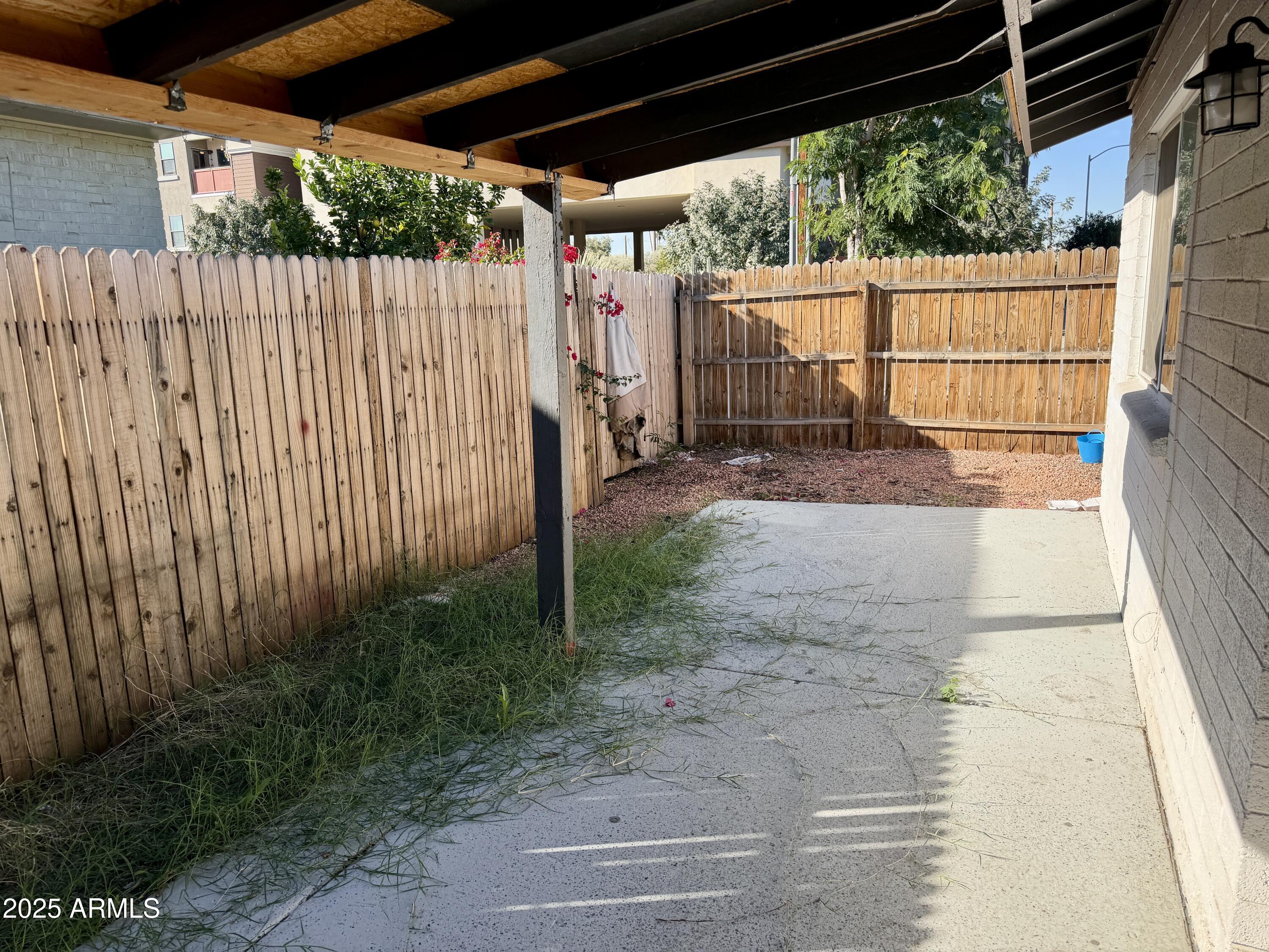5027 North 16th Avenue, Unit 1 Phoenix, AZ 85015 - Photo 8 of 9 a view of a backyard with wooden fence