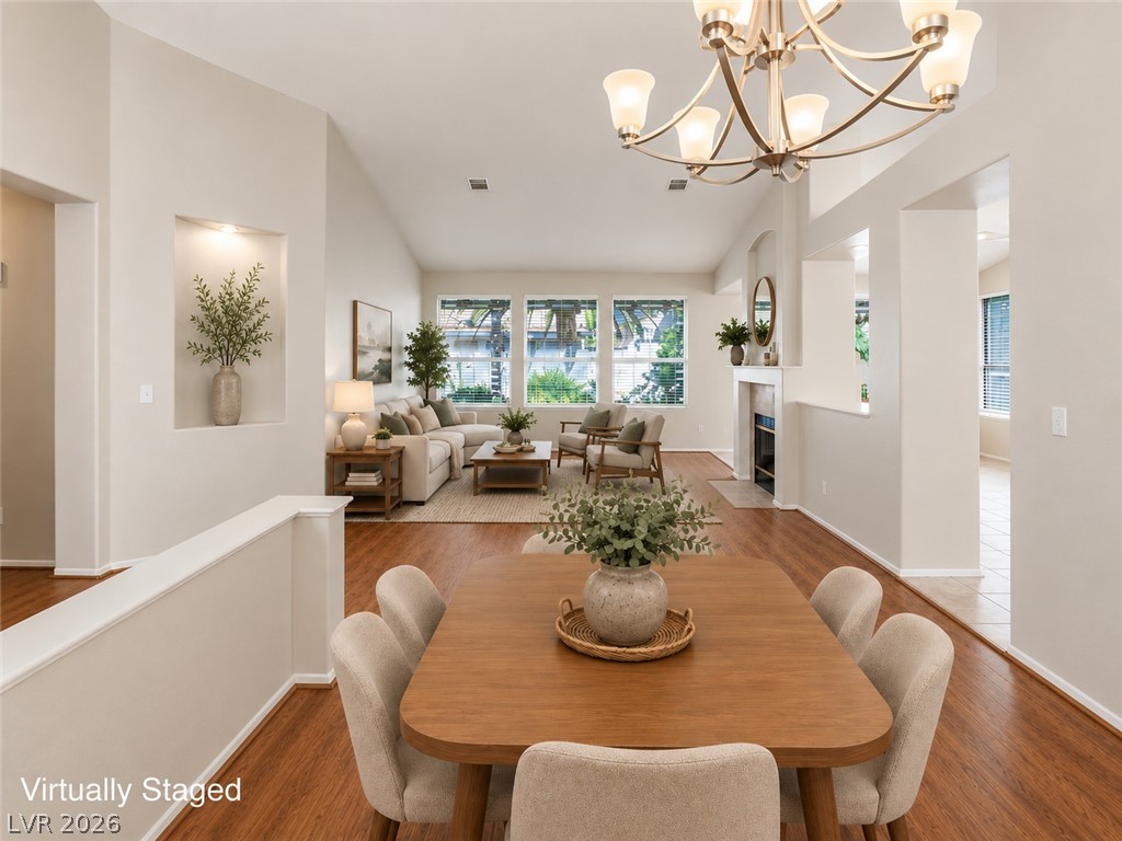 9034 Ridgepointe Way Henderson, NV 89074 - Photo 8 of 56 High vaulted ceilings and rich wood floors create an airy, connected dining and living space.