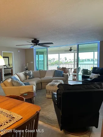 a living room with furniture a large window and a flat screen tv